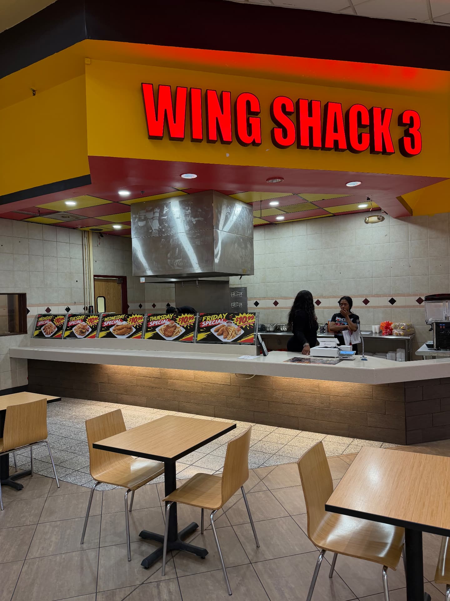Wing Shack 3 counter with daily specials and red sign inside McCain Mall
